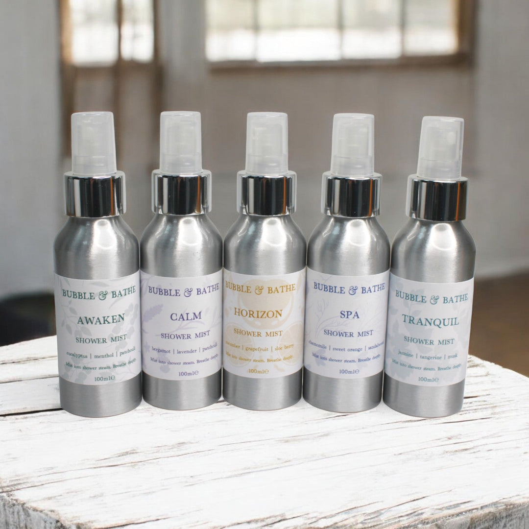 The complete collection of Bubble & Bathe Aromatherapy Shower Mists featuring all five scent blends: Awaken, Calm, Horizon, Spa, and Tranquil.