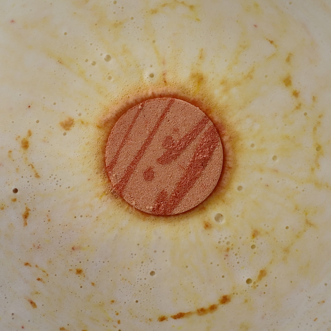 Amalfi - This is a close-up image of a colourful, handmade moisturising bath bomb, designed for a relaxing spa bath experience, highlighting its natural ingredients and textured surface, perfect for aromatherapy and soothing skin.