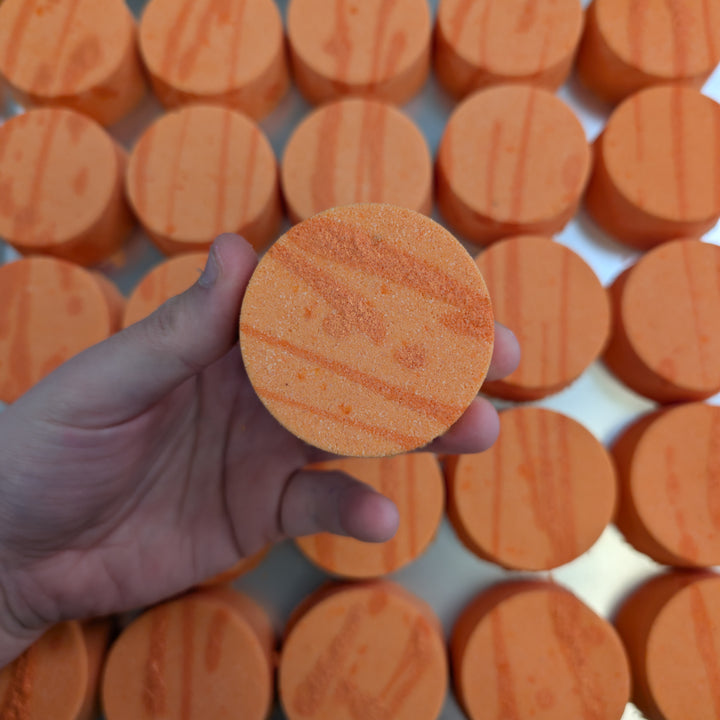Amalfi - This is a close-up image of a colourful, handmade moisturising bath bomb, designed for a relaxing spa bath experience, highlighting its natural ingredients and textured surface, perfect for aromatherapy and soothing skin.