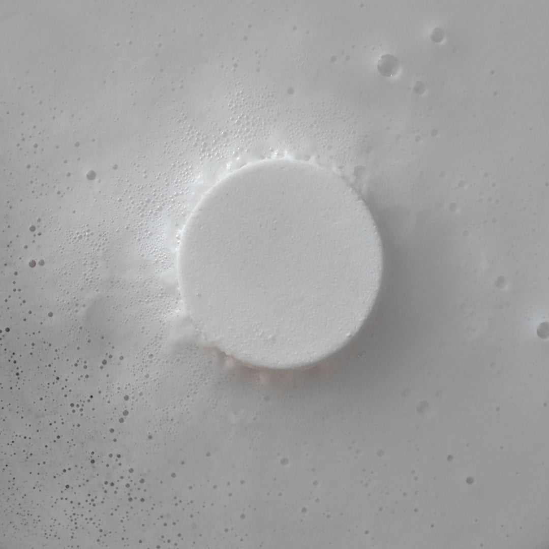 Coconut - This is a close-up image of a colourful, handmade moisturising bath bomb, designed for a relaxing spa bath experience, highlighting its natural ingredients and textured surface, perfect for aromatherapy and soothing skin.