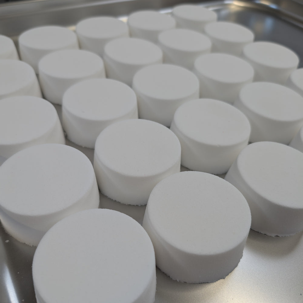 Coconut - This is a close-up image of a colourful, handmade moisturising bath bomb, designed for a relaxing spa bath experience, highlighting its natural ingredients and textured surface, perfect for aromatherapy and soothing skin.