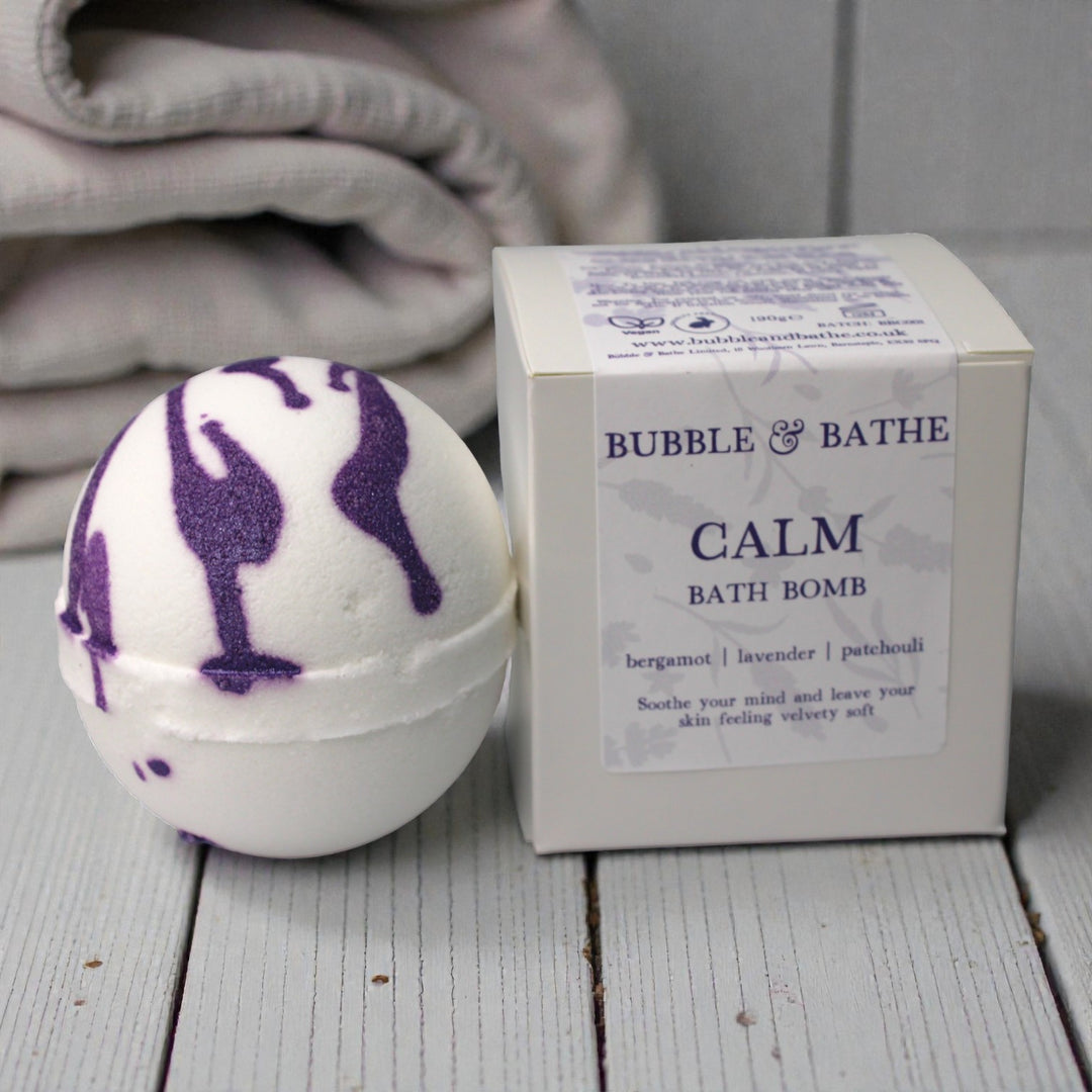 Soothing Calm bath fizzer creating a purple, lavender-scented sanctuary in the bathtub.