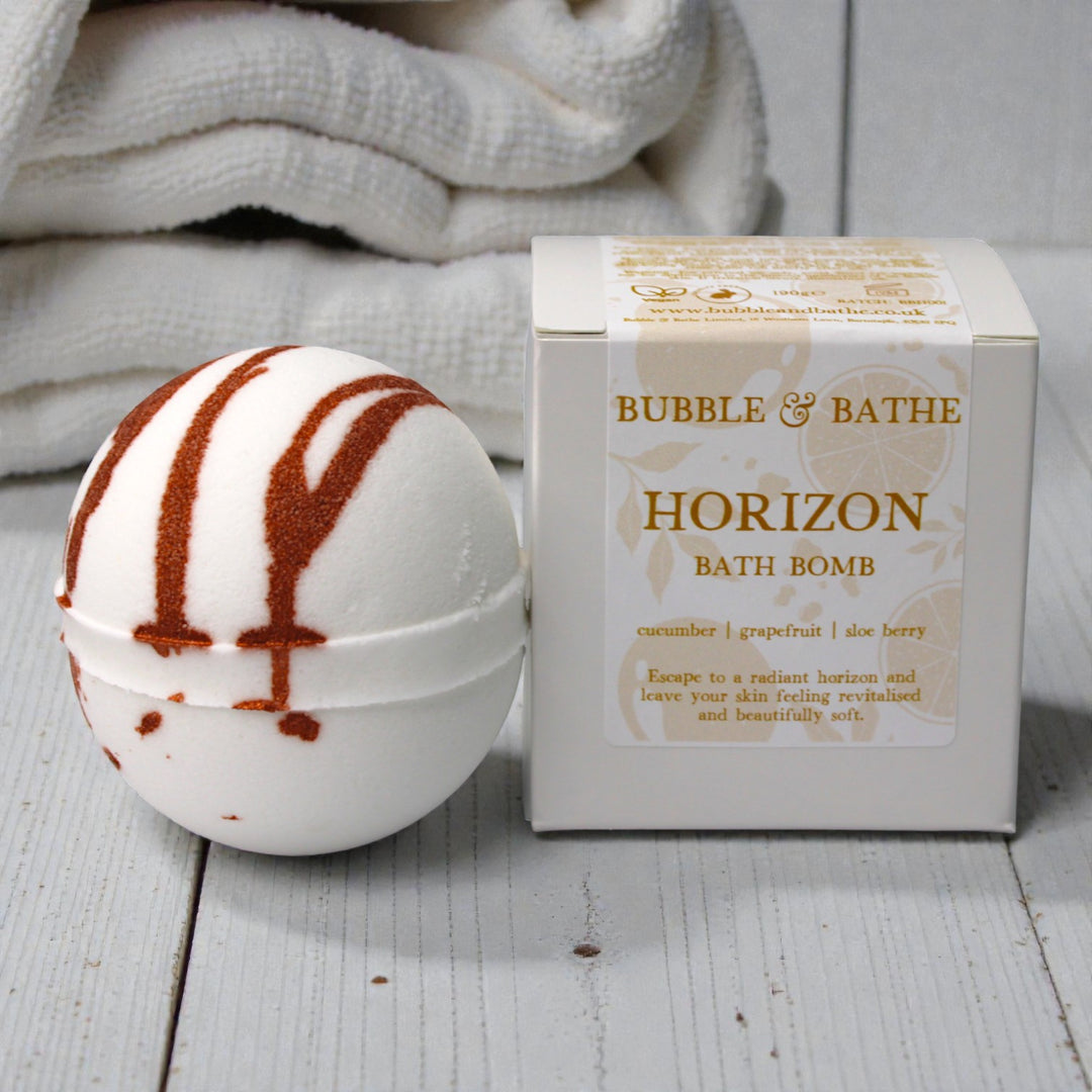 Bright Horizon bath bomb dissolving to create a sunny, summer-inspired bathing experience.