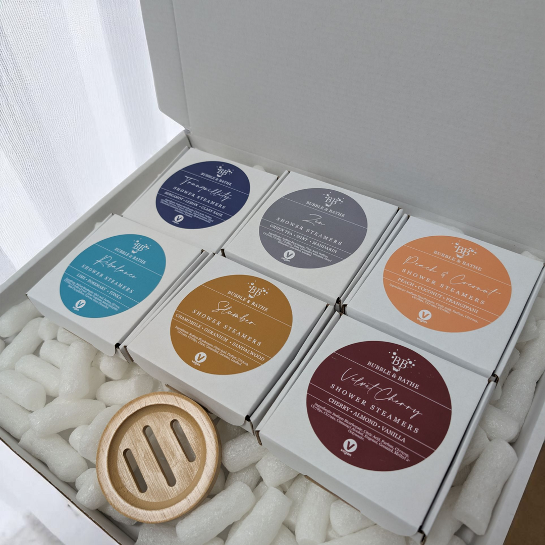 Shower Steamers Mystery Box by Bubble & Bathe, includes six boxes of vegan shower steamers and a bamboo tray, handmade in North Devon, assorted scents, plastic-free packaging