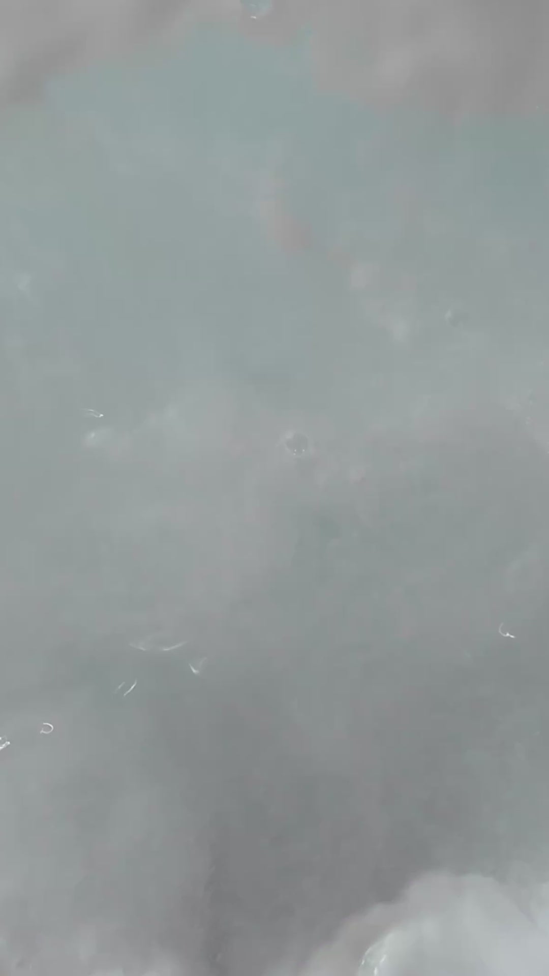 Coconut - This is a close-up video of a colourful, handmade moisturising bath bomb, designed for a relaxing spa bath experience, highlighting its natural ingredients and textured surface, perfect for aromatherapy and soothing skin.