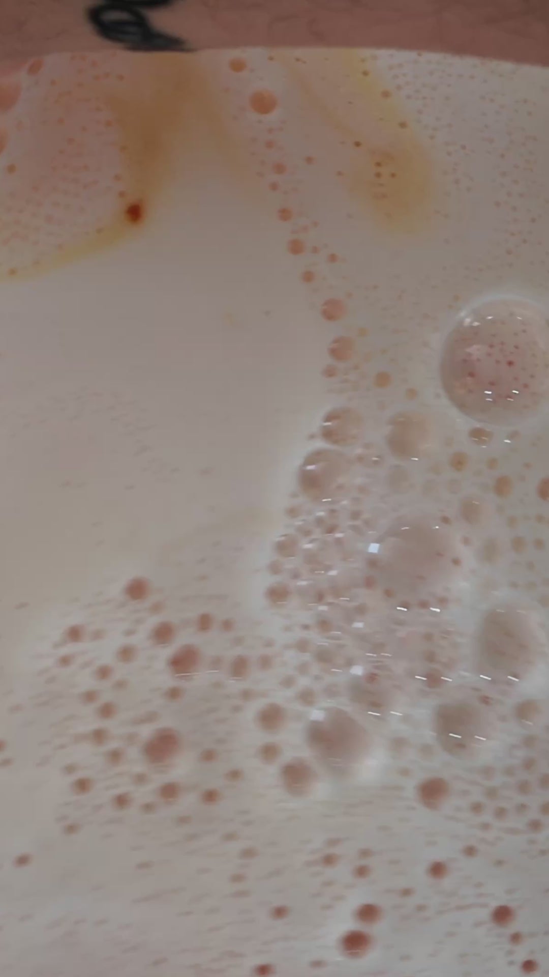 Amalfi - This is a close-up video of a colourful, handmade moisturising bath bomb, designed for a relaxing spa bath experience, highlighting its natural ingredients and textured surface, perfect for aromatherapy and soothing skin.